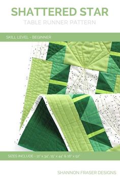 a green and white quilted table runner with the words, shattered star on it