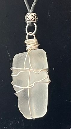 Beautiful sea glass pendent, adorned with a silver bead and clasp assembly on a leather cord. The light white opaque tone is in keeping with the quiet luxury trend in fashion. This is an excellent gift for birthdays, anniversaries, etc. tarnish resistant and hypoallergenic. Wire Wrapped Silver Recycled Glass Jewelry, Wire Wrapped Silver Jewelry With Recycled Glass, White Recycled Glass Jewelry Gift, Ocean-inspired White Sterling Silver Jewelry, Silver Wire Wrapped Ocean-themed Jewelry, Silver Wire Wrapped Ocean-inspired Jewelry, Silver Ocean-inspired Wire Wrapped Jewelry, White Recycled Glass Jewelry For The Beach, Handmade White Sea Glass Jewelry