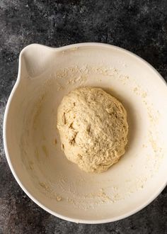 a ball of dough in a white bowl