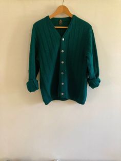 Fabulous vintage Ren-Dale knit cardigan in rich hunter green. The shade was hard to capture, just beautiful in person. Featuring a beautiful striped knit and finished with mother-of-pearl style buttons, this virgin wool cardigan is a perfect staple for spring and fall.  No flaws to note.  Marked a size Medium, I believe this is a men's sweater but would work for any gender.  Visit the Clothes | Shoes | Bags section for more handsome vintage menswear: https://www.etsy.com/ca/shop/LotusRoadVintage?section_id=27662622 Please visit my shop to see more gorgeous quality vintage items for your modern home: https://www.etsy.com/ca/shop/LotusRoadVintage?ref=seller-platform-mcnav Exciting news! Lotus Road Vintage has expanded and has launched a sister shop featuring only vintage print advertising. P Classic Green Wool Cardigan, Classic Green Textured Knit Sweater, Green Textured Knit Cardigan For Winter, Retro Green Winter Sweater, Green Retro Winter Sweater, Vintage Green Knit Outerwear, Vintage Green Knit Tops, Vintage Green Knit Sweater, Retro Green Knitted Sweater