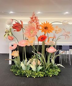 an arrangement of flowers on display in a room