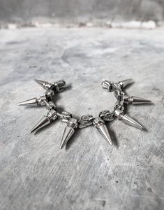 "Snake vertebrae cast in metal, set between large spikes.  Made with a unique flexible design, this spiked bracelet can flex to contour around your wrist.  Suitable for men and women, it fits between a 6.5\" on the tightest setting and 8\" on the loosest setting. If you need a different size range, specify when ordering. CURRENTLY MADE TO ORDER 3 WEEKS ETA" Rock Style Metal Jewelry For Streetwear, Rock Style Metal Bracelets With Studs, Punk Metal Bracelets With Studs, Edgy Metal Jewelry With Spikes, Silver Punk Bracelets With Spikes, Gothic Metal Bracelets With Spikes, Gothic Metal Bracelet With Studs, Rock Style Metal Bracelet With Spikes, Rocker Silver Bracelets With Spikes