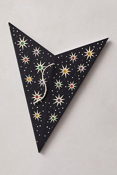 an origami triangle with stars on it