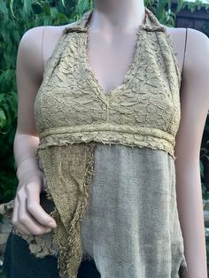 Introducing the Earthy Pixie Halter, our Lace and Rag Cotton Asymmetrical Boho Hippie Tribal Open Tie-Back Summer Halter Top. This unique piece is crafted with intricate lace detailing and soft, breathable rag cotton, perfect for those warm summer days. The asymmetrical design adds a touch of avant-garde style, while the boho hippie tribal influences bring a free-spirited charm to your wardrobe. Featuring an open tie-back for an adjustable fit, this halter top is both comfortable and stylish, ma Cheap Bohemian Halter Top, Lace Patchwork Tops, Summer Lace Top With Patchwork, Summer Lace Patchwork Tops, Bohemian Festival Lace Top, Bohemian Cotton Lace Patchwork Top, Bohemian Lace Patchwork Top For Festivals, Bohemian Cotton Lace Top With Crochet Trim, Festival Lace Tops With Lace Trim