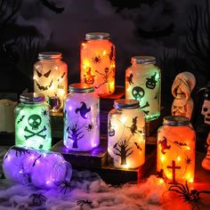 halloween mason jars with colorful lights and decorations