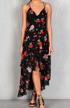 Our Floral Tiered Ruffle High-Lo Maxi Dress is a bestseller! Perfectly draped and flowy, this dress is great for weddings, date nights, parties, or vacation. This dress is sure to stun and get lots of compliments with its criss-cross adjustable straps, high-low hem with subtle ruffles, and beautiful red and black floral print! This dress is a bestseller! Don't wait for it to sell out! Hi-low hem with slight ruffle Criss-cross adjustable straps Back zip closure with hook & eye Lined 100% Poly Summer Flirty Maxi Dress With Ruffled Skirt, Flirty Summer Maxi Dress, Summer Chiffon Maxi Dress With Ruffled Skirt, Chiffon Midi Sundress With Ruffles, Flirty Flowy Maxi Dress With Ruffles, Flirty Flowy Floral Print Dress, Flirty Fitted Tiered Maxi Dress, Flirty Ruffled Skirt Dress For Vacation, Flirty Maxi Dress For Brunch