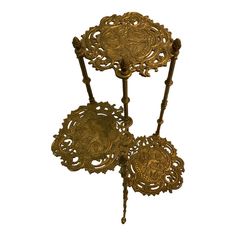 three tiered trays with ornate designs on each side and an intricate design on the top