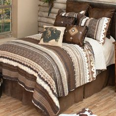 a bed with brown and white comforters in a bedroom