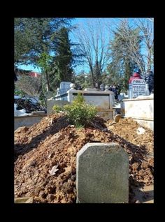 a pile of dirt sitting next to two headstones