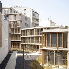 an apartment building with many balconies and windows on the side of each building