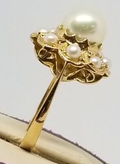 "We do not check prongs for wear or stones for looseness. All items are sold as is-noting that we are a resale shop so everything here had a previous owner! We will include flaws in the description when noted. This is one of the reasons our items are more affordable than new at a jewelry store. Vintage 18K Yellow Gold Pearl Ring, Size 6. Stamped K18 inside band. Main Pearl is 7.2mm others are 2.5mm. Weighs 2.1 dwt. Please stop in often as we will be adding additional vintage fine jewelry beautie European Jewelry, Gold Pearl Ring, Vintage Fine Jewelry, Opal Ring Gold, Please Stop, Gold Pearl, Sapphire Diamond, Pearl Ring, Opal Rings