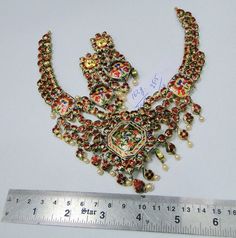 "20 carat solid gold, Old cut Diamonds and multicolor Enamel work necklace (Kundan Meena choker)with Matching Earrings. A large necklace Ideal for special occasions set with eye popping clear old cut genuine Diamonds. A solid piece of jewelry good for family Heirloom which will last for ever. Multicolor enamel at the back giving this piece a unique look of quality, great workmanship and great value for Money. Length of necklace -25 cm (9.84\") Size could be adjusted according to your requierment Ceremonial 22k Gold Multicolor Jewelry, Multicolor 17 Jewels Temple Necklace, Multicolor Temple Necklace With 17 Jewels, Heavy Multicolor Jewelry For Festivals, Heavy Multicolor Jewelry For Ceremonial Occasions, Ornate Multicolor Meenakari Jewelry, Ornate Multicolor Jewelry For Festive Season, Bold Multicolor Ceremonial Jewelry, Ornate Multicolor Festival Jewelry