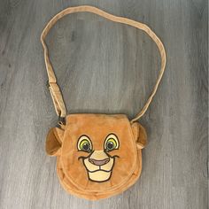 the lion bag is on the floor and ready to be used as a handbag