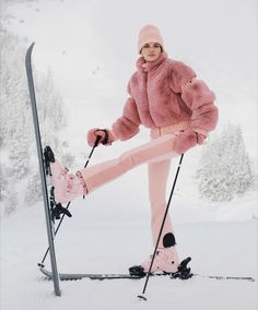 a woman in pink is posing on skis