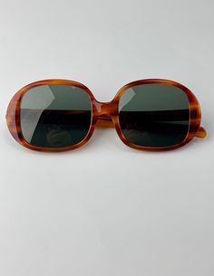 "Vintage 1960'S Ray-Ban Oval Sunglasses in a tortoise colored frame. These Optical Quality frames have the original glass lenses in a smokey green color.  On the inside of one stem is etched \"B & L Ray-Ban USA\" and on the other side is etched \"Kilaine\" These sunglasses are Used and in EXCELLENT VINTAGE CONDITION. there are a few very minor scratches, otherwise, no issues to mention. The hinges are in excellent working order, and the frames are not warped or crooked. *For a good fit, compare Vintage Ray Ban, Tortoise Color, Stylish Glasses, Walk In Wardrobe, Style Upgrade, Oval Sunglasses, B L, Designer Sunglasses, Eyewear Sunglasses