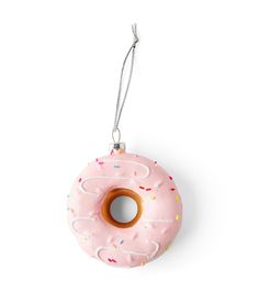 a pink donut with sprinkles hanging from a string