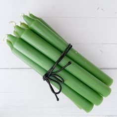 a bunch of green candles tied up together