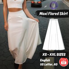 a woman in a white skirt and crop top walking down the street with her hand on her hip