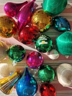 many different colored glass ornaments on a table