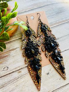 Crackle Ab gold black crystal bling feather earring/boho feather earring/long crystal earring/bling crystal leather earring/gold black  Long crackle Ab gold black crystal chandlier feather statement earrings .These are super cute and pictures do not do it justice ! Pictures don't quite show the shimmer on these !Ooak and super cute !Don't let these slip by!  Earring hooks are black gunmetal  and are  lead/nickel free .Ready to sell will ship out same or next day in a gift box with tracking:) tha Long Crystal Earrings, Boho Feathers, Earring Long, Earring Gold, Leather Earring, Earring Hooks, Feather Earrings, Black Crystals, Leather Earrings