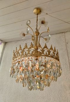 a gold chandelier hanging from the ceiling