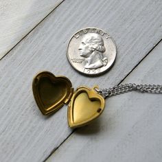 "A vintage brass heart locket hangs from a vintage stainless steel chain to make this simple and easy to wear necklace. The locket measures 7/8\" long and is NOS (new old stock) vintage with varying amounts of patina and scratches on the surface. Choose length at checkout: 16\". 18\". 20\". 22\". 24\". More heart jewelry can be found here: http://etsy.me/1Stzj2o To see more of my handmade jewelry in my Etsy shop, click this link: WearYourWild.etsy.com All jewelry comes nestled in recycled, rusti Vintage Brass Heart Charm Necklace, Vintage Charm Heart-shaped Brass Necklace, Brass Heart Necklace With Vintage Charm, Heart-shaped Brass Necklace With Vintage Charm, Vintage Gold Heart Metal Necklace, Gold Brass Heart Pendant Locket Necklace, Gold Heart Pendant Locket Necklace In Brass, Vintage Charm Necklace For Anniversary, Valentine's Day Brass Locket Necklace