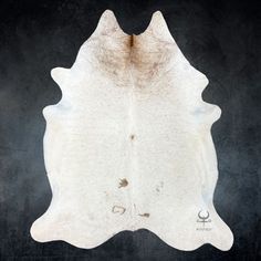 a white cowhide rug on a black background