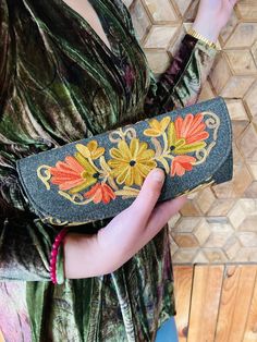 This handcrafted clutch handbag with beautiful floral embroidery is elegant and stylish. Especially suitable for special occasions and evenings, it is handmade by skilled Kashmiri artisans, Inside it has a black lining and features 4 compartments from which 2 zippered plus a special space for cards and photo. There is also another zippered pocket on the rear side. It closes by magnetic button clasp. Incredibly spacious! The size is 24 cm length x12 cm height. The body is in faux leather and it i Embroidered Clutch Evening Bag For Festivals, Festival Clutch With Gold Embroidery, Festive Clutch With Floral Embroidery, Embroidered Clutch For Festivals, Floral Embroidered Clutch Gift, Traditional Embroidered Clutch For Events, Traditional Clutch Evening Bag With Floral Embroidery, Multicolor Embroidered Clutch For Evening, Traditional Floral Embroidered Clutch Evening Bag