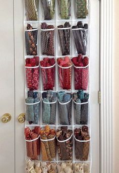 an over the door shoe rack holds many pairs of booties and shoes in clear storage baskets