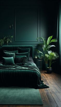 a bed with green sheets and pillows in a dark room next to potted plants