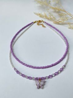 This dainty, layered necklace is beautifully crafted, and brings a whimsical touch to any outfit. Beautiful  purple-beaded necklace made with seed beads and a purple butterfly pendant. Each necklace is handmade and carefully crafted to ensure durability for everyday wear.  This two-layer necklace is attached with a crimp bead for a nice, neat look. The layers of the necklace differ by one inch in length, with an adjustable 2 inch extender chain (the size listed is for the SHORTER layer). I offer nine different lengths. If you would like a different length, please feel free to leave a message. My business thrives on Customer Satisfaction Please do not hesitate to reach me if there is something wrong with your purchase. I will try my best to make it right for you. Thank you for shopping JGBe Trendy White Layered Necklace As Gift, Trendy White Layered Necklace For Gift, Trendy Summer Layering Necklaces, Adjustable Beaded Chain Layered Necklace Gift, Adjustable Beaded Chain Layered Necklace For Gift, Adjustable Layered Necklace As Gift, Adjustable Layered Necklace Gift, Summer Gift Purple Beaded Necklaces, Trendy Purple Beaded Necklace For Gift