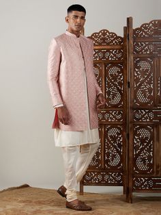 Vastramay Men's Peach Sequined Indo Western Sherwani With Kurta Pyjama Set Make a statement at weddings and festive occasions with this elegant Indo Western Sherwani set from VASTRAMAY. Crafted in a peach hue with sequin detailing, this outfit exudes traditional charm with a modern twist. The set includes a Sherwani and matching Kurta Pyjama. Features: Sequined detailing for a stylish look Modern Indo Western design Includes Sherwani and Kurta Pyjama Perfect for weddings and festive occasions Specifications: Brand: VASTRAMAY Color: Peach Material: Sequins Occasion: Wedding, Festive Fit: Regular Material & Care: Sequins Dry clean only Legal Disclaimer: The product is guaranteed to be 100% genuine. Product images are for illustrative purposes only. Images/packaging/ labels may vary from time Pink Naqshi Kurta For Festivals, Pink Salwar Kameez With Naqshi In Traditional Drape, Pink Salwar Kameez With Naqshi Drape, Festive Pink Kurta With Naqshi Details, Pink Naqshi Salwar Kameez Traditional Drape, Pink Traditional Wear With Naqshi For Festivals, Pink Naqshi Salwar Kameez For Wedding, Pink Naqshi Kurta For Festive Occasions, Festive Kurta With Naqshi For Reception