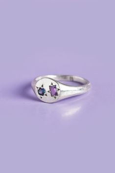 Experience the perfect blend of elegance and playfulness with our Delicate Pickles Mini Signet. Its eye-catching gemstones, including a mesmerizing blue-green Sapphire and an Amethyst, star-set in the face, make it a must-have for those who love to have fun with their jewellery. Use the drop down to select your ring size.If you are unsure of your ring size refer to our size guide. Please select your ring size carefully, and reach out if you have any questions. Details925 Sterling SilverHandcraft Blue Green Sapphires, The Drop, Green Sapphire, Have Fun, Pickles, Make It, The Face, Size Guide, Blue Green