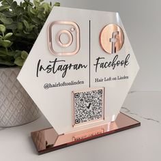 the instagram award is on display next to a potted plant