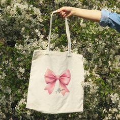 Cute tote bag gift with big pink bow personalized Name custom canvas tote bag. Perfect Girly gift for teenage girl, best friend, birthday gift, or any girly occasion. For Personalization: Please include Name(s) to be printed on each tote bag, in the Personalization box. Print is on one side only. This Classic tote bag is 100% cotton canvas, comes in one size - 15" x 16" with 20" handles made from the same canvas material with no pockets. Great quality durable canvas material will last for many u Personalized Pink Bag For Mother's Day, Pink Canvas School Bag, Cute Canvas Bags For Gifts, Cute Pink Bags For Gifts, Cute Pink Canvas Bag For School, Customizable Canvas Bags For Gifts, Cute Pink Bag For Gift, Pink Everyday Bag For Mother's Day, Cute Pink Bag As Gift