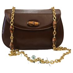 This vintage GUCCI bamboo chain shoulder bag is crafted of smooth calfskin leather in brown featuring a sturdy gold toned chain with bamboo internodes. Front flap bamboo turnlock closure opens to a new beige interior featuring a zippered pocket. Made in Italy. Measures approximately 8.75 x 6 x 3 inches Chain drop 18 inches. Comes with dustbag. Condition: Generally in good vintage condition with minor signs of wear Outside: Minor scratches on leather exterior Inside: Interior fully re-lined and f Gucci Chain Bag, Gucci Bamboo Bag, Gucci Vintage Bag, Structured Shoulder, Beige Interior, Chanel Flap Bag, Bamboo Bag, Gucci Outfits, Gucci Tote