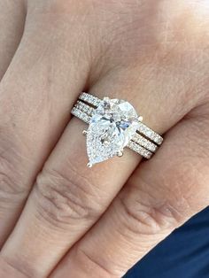 a woman's hand with a ring on it and a diamond in the middle