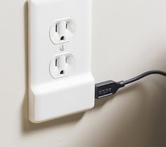 an electrical outlet is plugged into the wall with two black wires attached to it