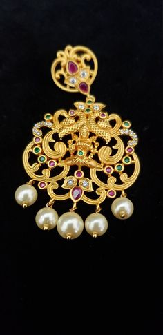 "Stunning Necklace with White, Ruby, Emerald, Pearls and Cubic Zircon. Handmade Indian Temple Jewelry, best to wear it for traditional ceremonies or Indian wedding. This bridal jewelry has ethnic finish. It has Cubic Zircon stones with ruby and emeralds. It is a Bollywood style one gram jewelry. There are long and short patterns of Indian jewelry in Kundan, Pearls, CZ, American Diamond , ruby, emerald, Polki, kemp to suit every occasion of South Indian and North Indian weddings. Handmade Indian Temple Jewelry Tikka For Marriage And Festivals, Traditional Kundan Necklace For Marriage Diwali, Traditional Kundan Necklace For Marriage, Traditional Kundan Necklace For Marriage And Diwali, Traditional Necklaces For Diwali Marriage, Traditional Necklaces For Marriage And Diwali, Traditional Gold Tikka For Marriage, Elegant Tikka For Marriage And Festivals, Elegant Marriage Tikka For Festivals