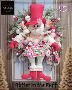 a stuffed animal in a pink dress and top hat surrounded by christmas decorations with the words glitter in the ruff written below