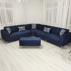 a blue sectional sofa with matching footstool and ottoman