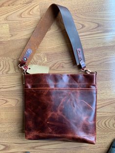 "Single pocket shoulder/crossbody tote made of 2-3 oz. Moore & Giles Leather in Walnut Brompton. Features d-rings that can accommodate shoulder or crossbody wear, finished with copper hardware.  Tote has interior magnetic closure on top. Pattern and style design by me, hand crafted in my shop. Features handmade 10\" drop shoulder strap that is removable, or an embroidered crossbody strap. 10\" wide by 9\" tall by 2\" wide. Features a lightweight leather in 2-3 oz. that is flexible and full grain On-the-go Satchel Shoulder Bag With Brass Hardware, Brown Saddle Bag With Adjustable Strap For Everyday, Everyday Tote Shoulder Bag With Brass Hardware, Leather Handles Satchel Shoulder Bag For Everyday, Everyday Carry Satchel With Leather Handles, Rectangular Waxed Shoulder Bag For Everyday, Everyday Crossbody Shoulder Bag With Brass Hardware, Rectangular Waxed Finish Shoulder Bag For Everyday, Leather Handle Tote Saddle Bag For Everyday Use