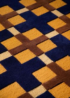 an orange and blue rug with squares on it