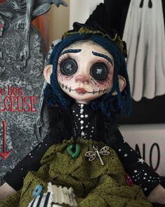 a creepy doll sitting next to a halloween decoration