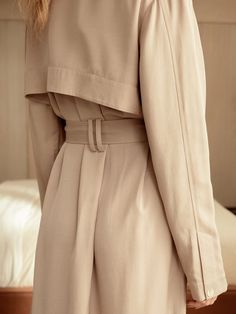 If there ever was a perfect lightweight trench, this is it. Made of a luxurious and flowy fabric, it's a stunning layering piece and can also be worn buttoned up as a dress. The color lies beautifully between beige and tan, providing a soft neutral tone that goes with literally anything in your closet, including all of our capsule pieces. With a tie belt, beautiful horn style buttons, lovely pleats, side slits and a back flap, its intentional design is what sets us apart. Whatever you pair this Chic Beige Outerwear With Belted Cuffs, Elegant Cream Outerwear With Belted Cuffs, Elegant Beige Belted Outerwear, Beige Belted Outerwear For Daywear, Beige Outerwear With Belted Cuffs For Spring, Beige Belted Cuffs Outerwear For Spring, Beige Formal Summer Outerwear, Formal Beige Summer Outerwear, Elegant Neutral Outerwear For Daywear