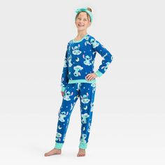 Bring the magic of a classic Disney hit to your kid's' wardrobe with this Lilo & Stitch 2-Piece Pajama Set and Headband in blue. This pack includes a headband, a long-sleeve sleep shirt with Lilo & Stitch prints designed with a crew neckline, and a pair of pajama pants with allover Lilo & Stitch prints for a fun, playful look. Tailored in a regular fit, this pajama set is great for movie nights and bedtime stories. Disney Cartoon Print Loungewear Sets, Blue Character Print Loungewear Sets, Disney Cotton Pajama Party Sets, Disney Cotton Sets For Pajama Party, Cotton Disney Sets For Pajama Party, Fitted Playful Blue Sleepwear, Playful Fitted Blue Sleepwear, Cute Blue Fitted Sleepwear, Cozy Pajamas