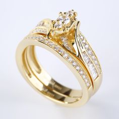 two gold wedding rings with diamond accents on each band and an engagement ring in the middle