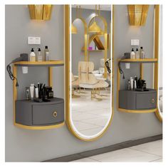 three mirrors with yellow trim around them in a room that has white tile flooring and gray walls