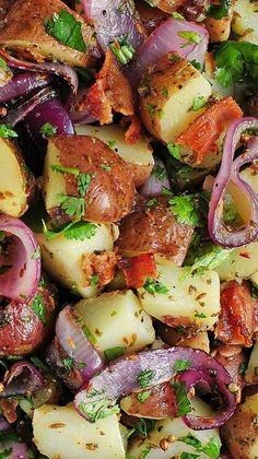 a plate full of potatoes, onions and meat with parsley on the top one