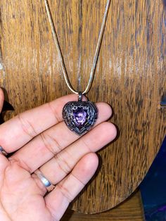 Beautiful vintage style beautiful purple Quartz stone heart necklace. In stirling silver. Has black CZ diamonds all over the charm. Unique item, very antique looking necklace. One of a kind. Spiritual Handmade Jewelry With Heart Pendant, Gothic Heart Pendant Metal Jewelry, Antique Gemstone Jewelry For Memorial, Vintage Jewelry With Heart Charm And Round Pendant, Vintage Heart Charm Round Pendant Jewelry, Vintage Round Pendant Jewelry With Heart Charm, Gothic Heart Necklaces With Heart Charm, Heart Pendant Metal Locket Jewelry, Antique Heart Pendant Metal Jewelry